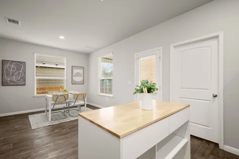 a view of kitchen island with wooden floor and living room
