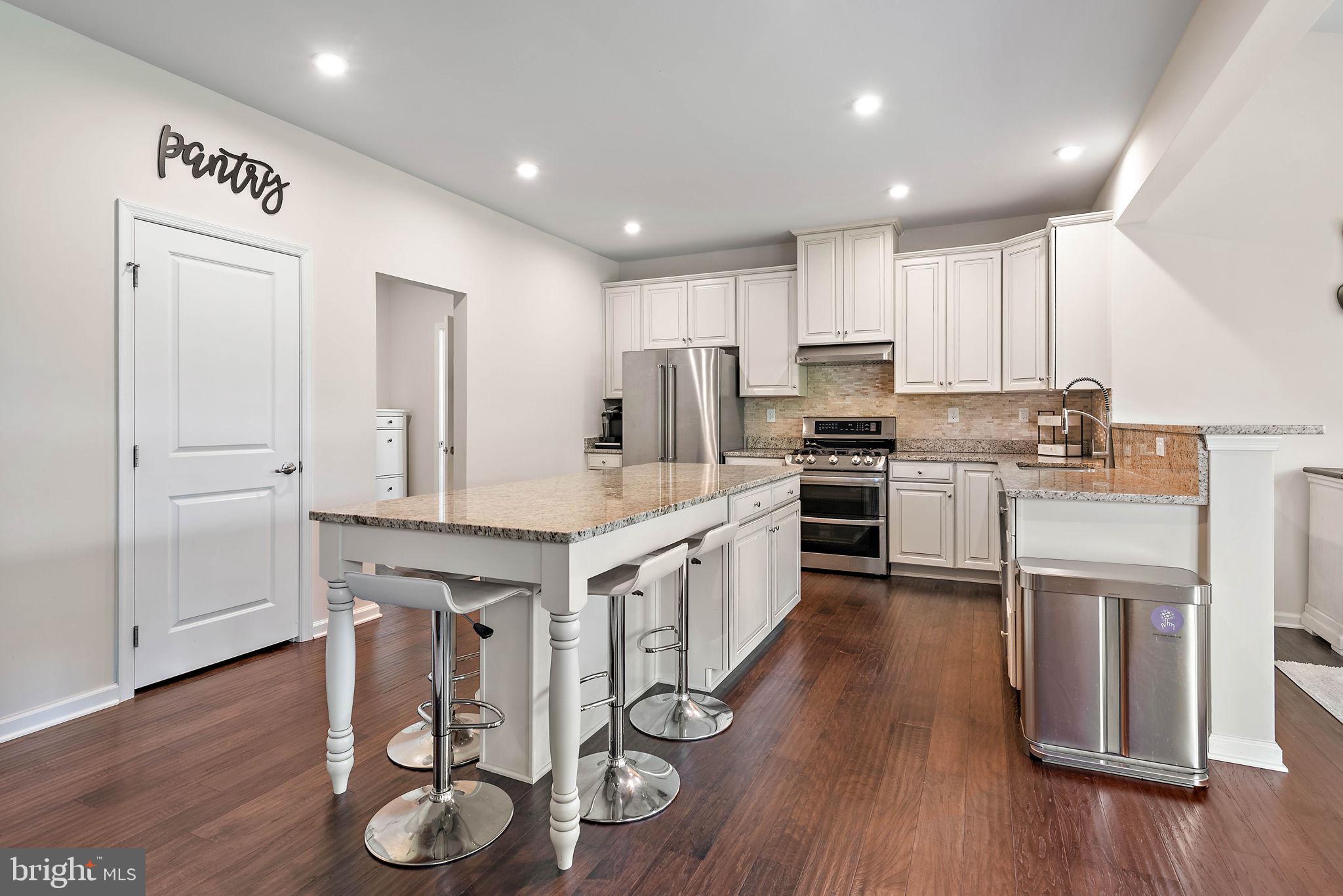 102 Pixie Moss Road Pottstown, PA 19464 - Photo 14 of 45 a kitchen with granite countertop white cabinets and stainless steel appliances
