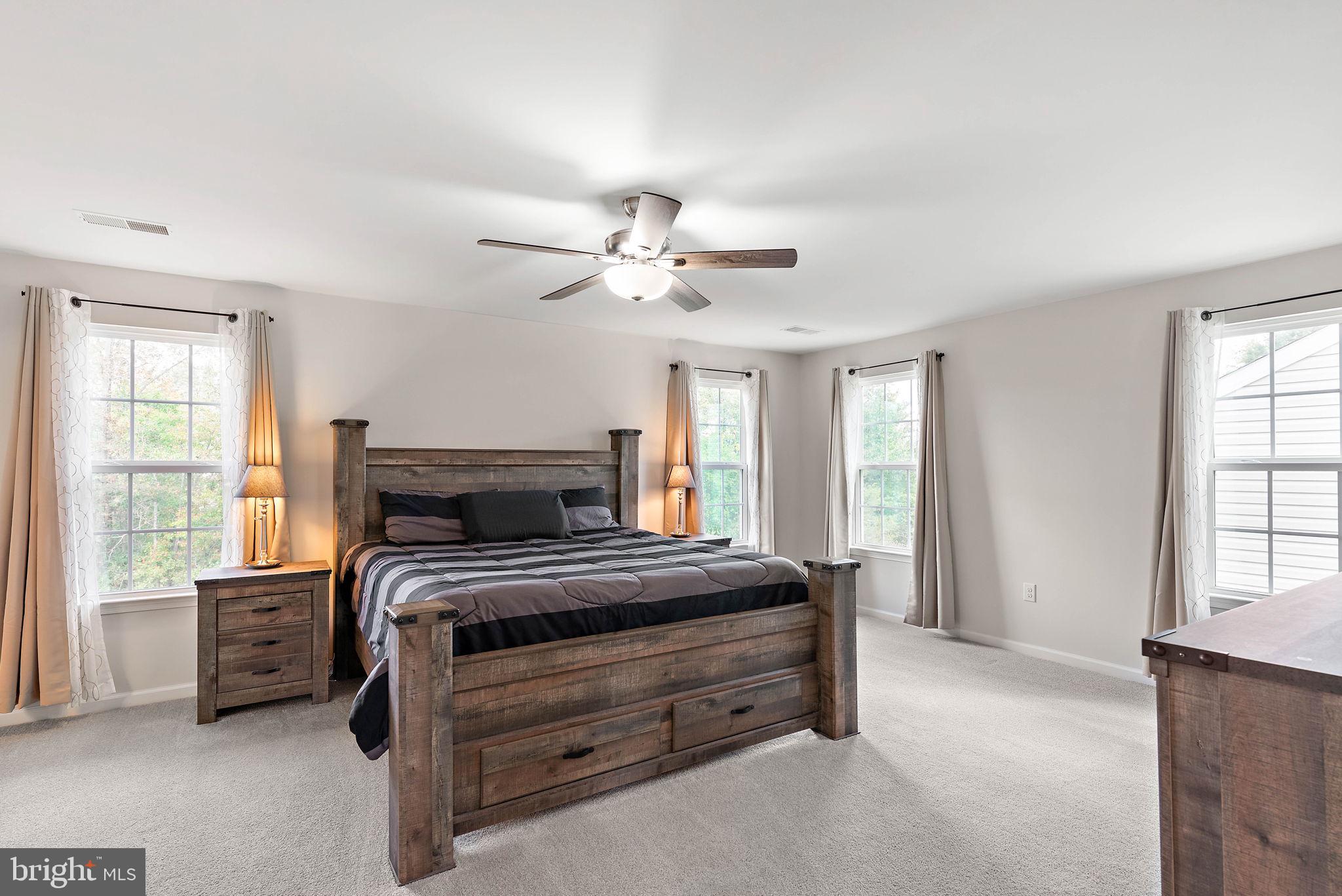 102 Pixie Moss Road Pottstown, PA 19464 - Photo 21 of 45 a bedroom with a bed a chandelier and a window