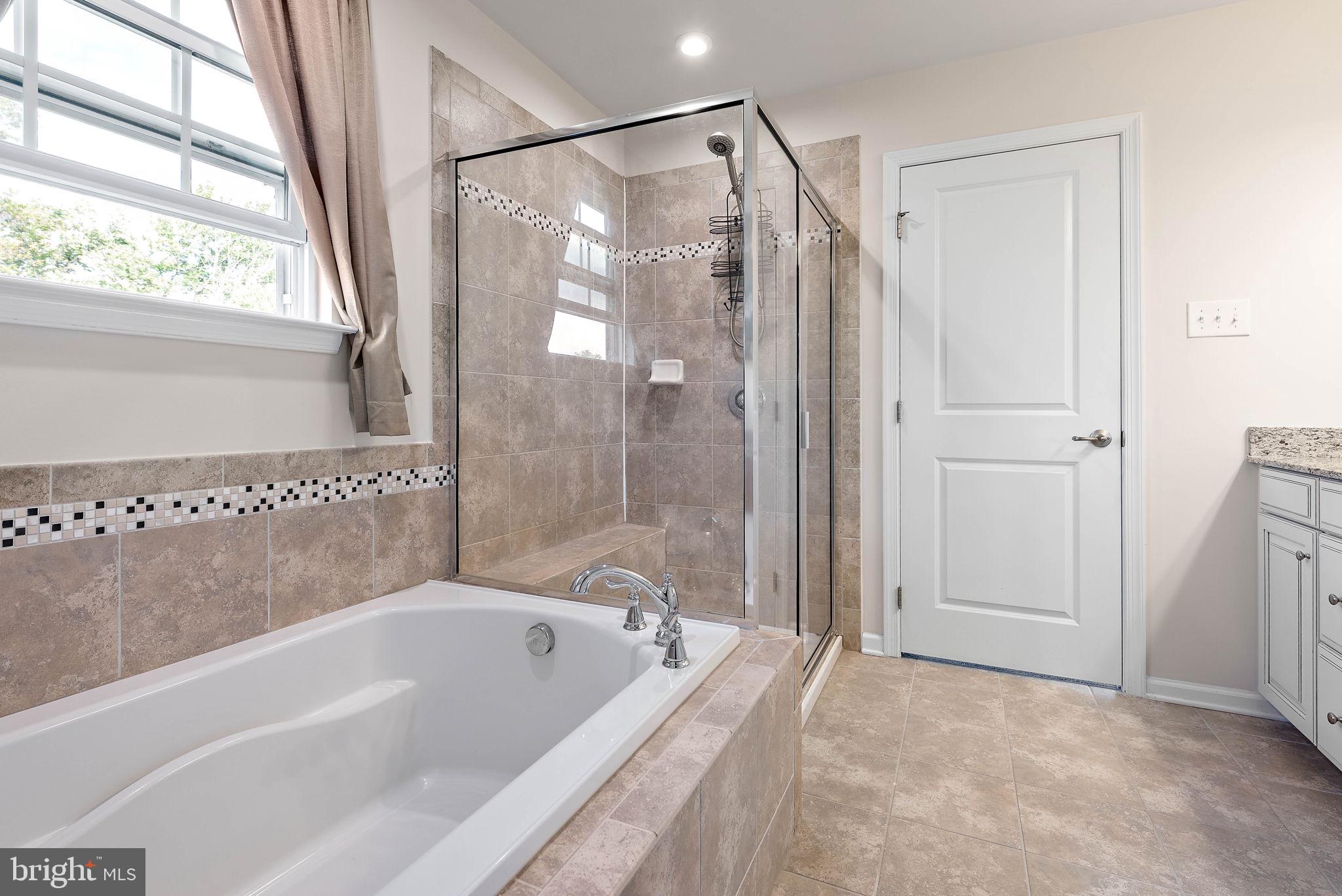 102 Pixie Moss Road Pottstown, PA 19464 - Photo 24 of 45 a bathroom with a bathtub a shower and a bathtub