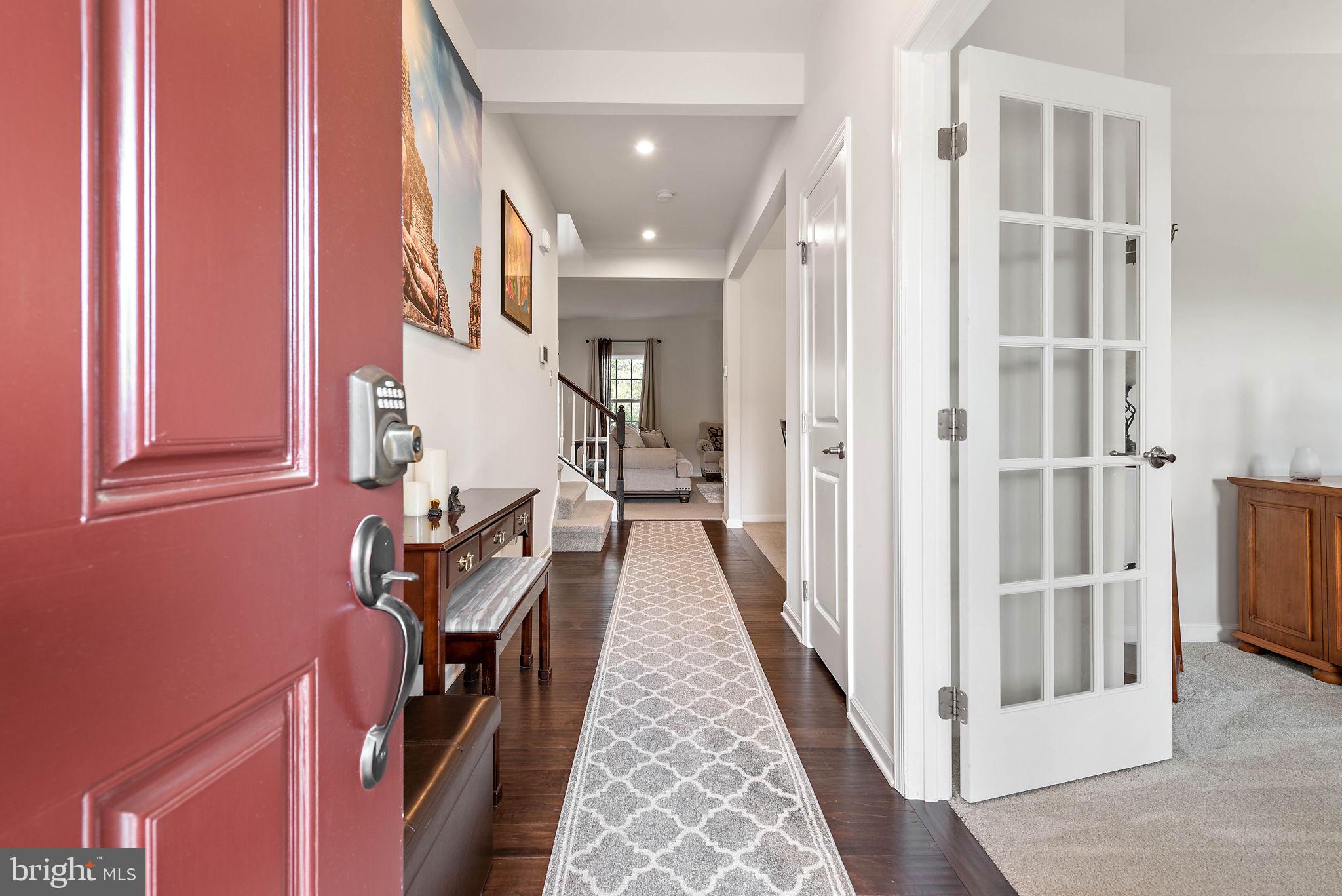 102 Pixie Moss Road Pottstown, PA 19464 - Photo 4 of 45 a view of a hallway with wooden floor and staircase