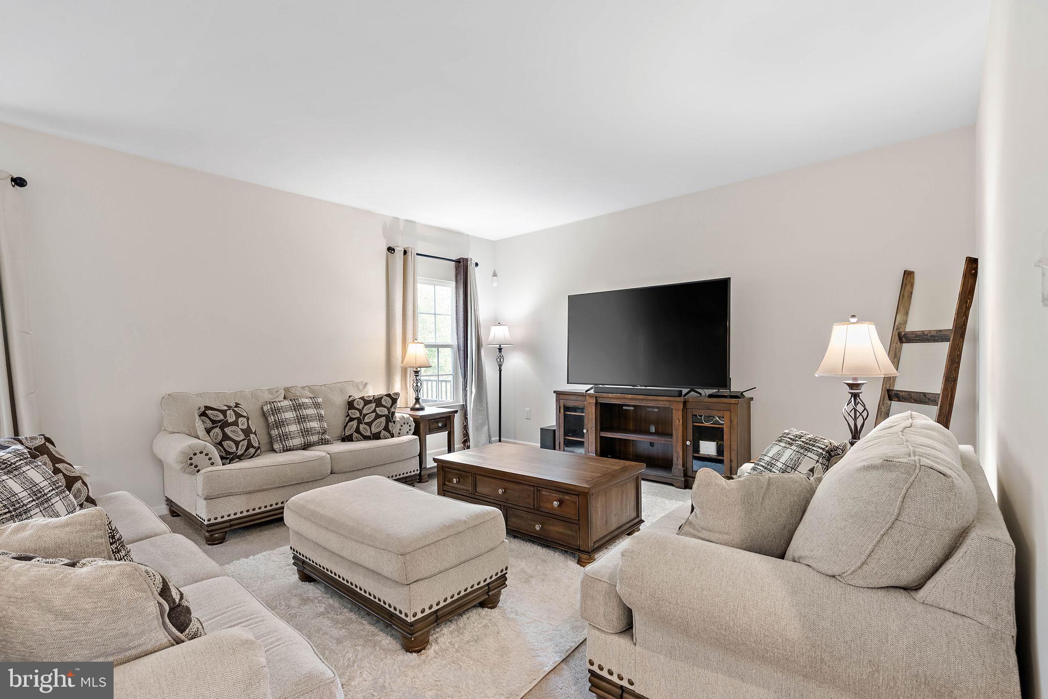 102 Pixie Moss Road Pottstown, PA 19464 - Photo 6 of 45 a living room with furniture and a flat screen tv