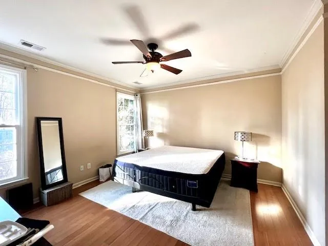 a bed room with a bed window and a chandelier