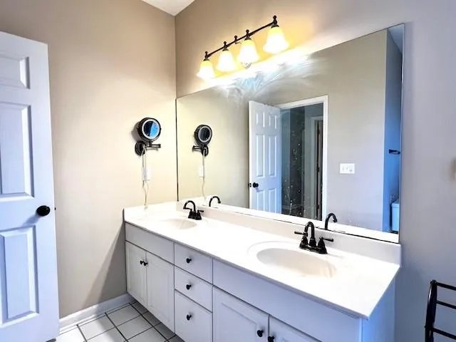 a bathroom with a double vanity sink and a mirror