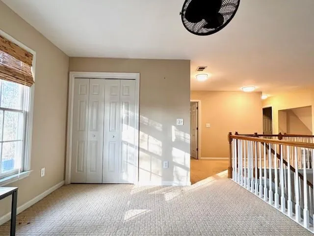 a view of a room with wooden floor and windows