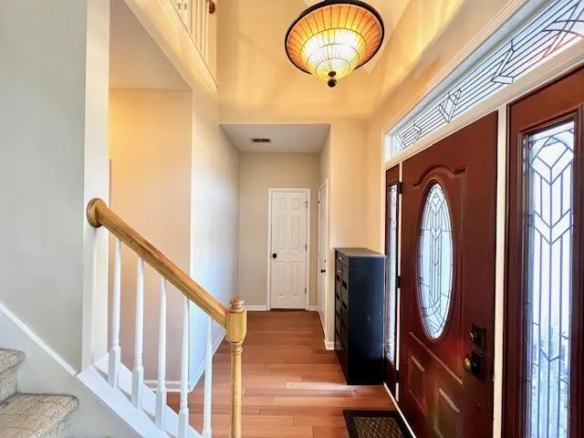 a view of a hallway with wooden floor and entryway