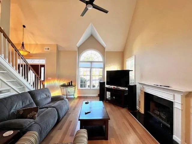 a living room with furniture a flat screen tv and a fireplace