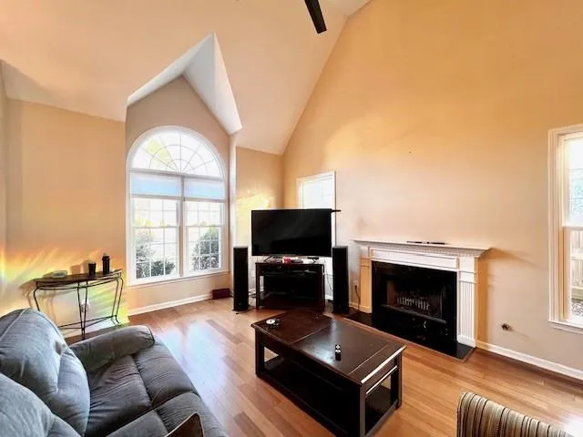 a living room with furniture a flat screen tv and a fireplace