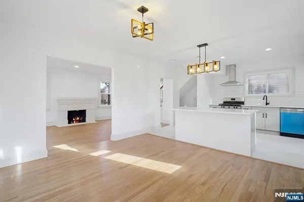 a kitchen with granite countertop a refrigerator and a stove top oven
