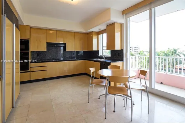 a kitchen with granite countertop a stove a sink and a microwave