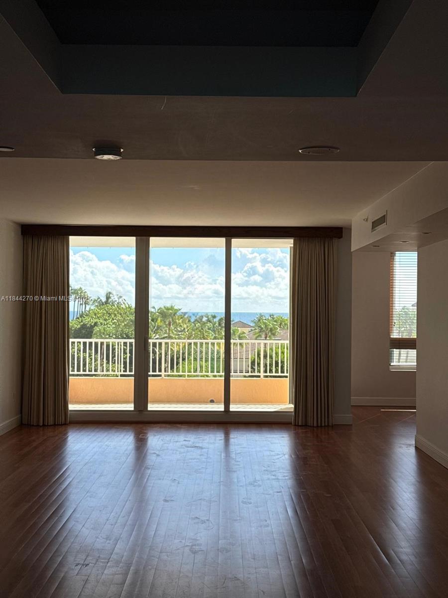785 Crandon Boulevard, Unit 506 Key Biscayne, FL 33149 - Photo 23 of 58 a view of an empty room with wooden floor and a window