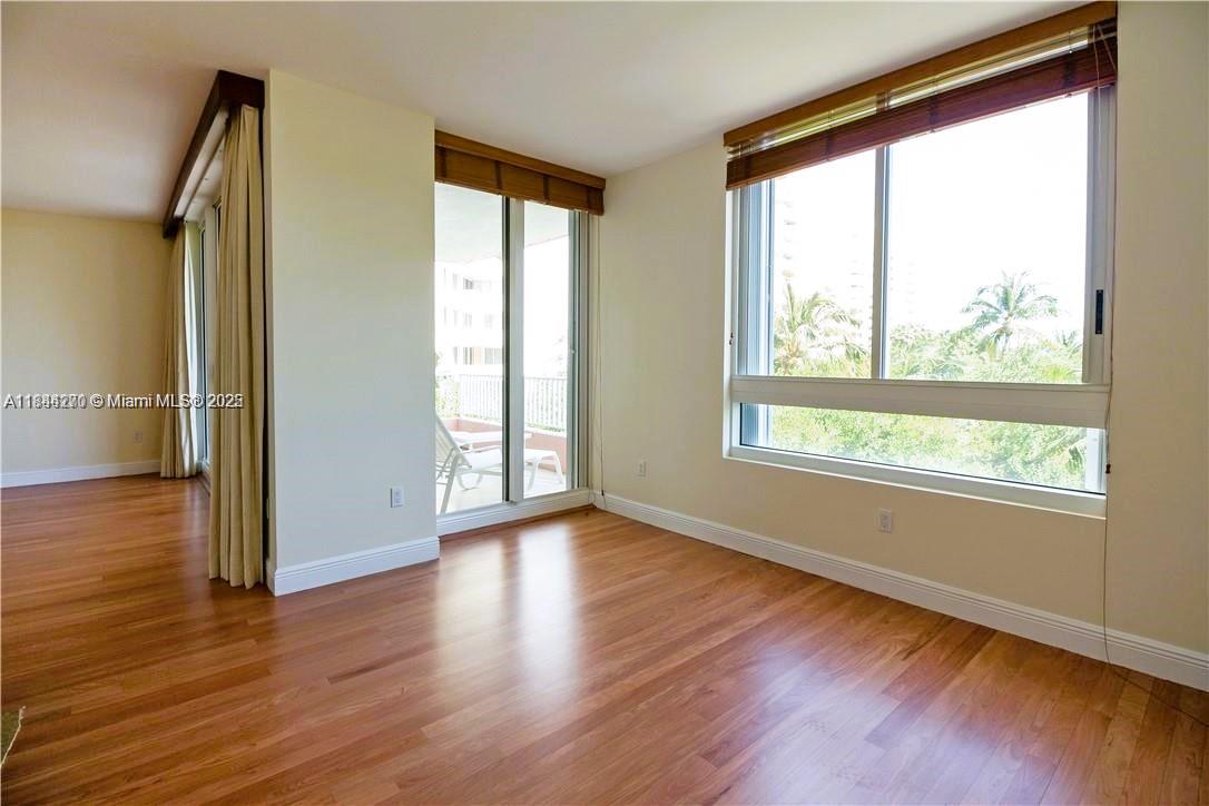 785 Crandon Boulevard, Unit 506 Key Biscayne, FL 33149 - Photo 3 of 58 a view of an empty room with wooden floor and a window