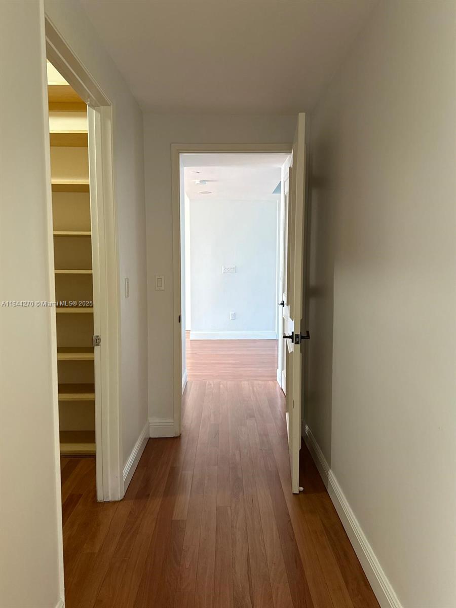 785 Crandon Boulevard, Unit 506 Key Biscayne, FL 33149 - Photo 41 of 58 an empty room with wooden floor and entrance