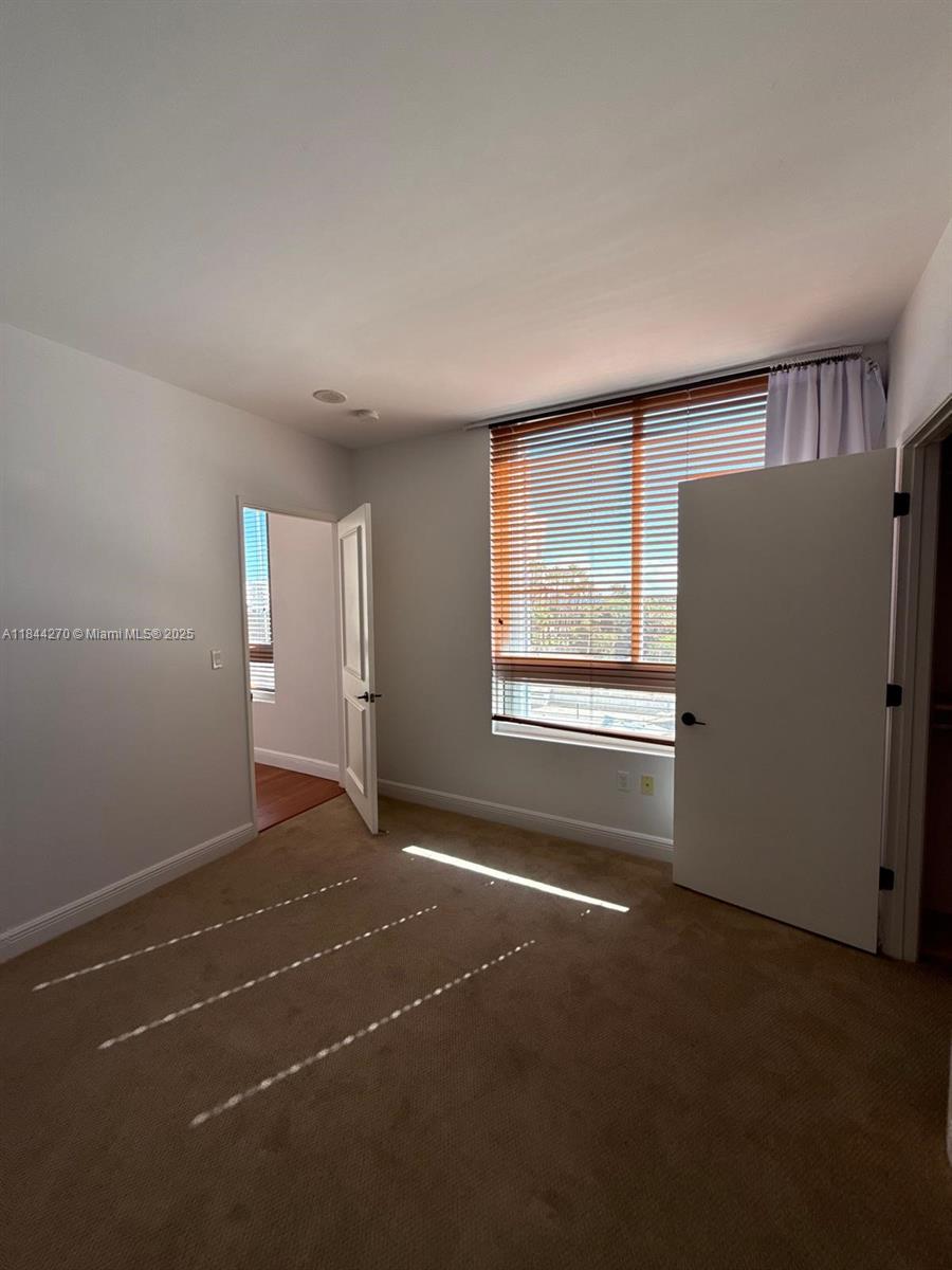 785 Crandon Boulevard, Unit 506 Key Biscayne, FL 33149 - Photo 49 of 58 a view of an empty room with a window