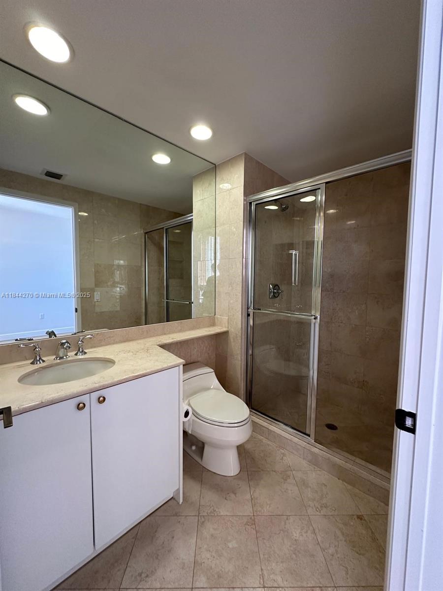 785 Crandon Boulevard, Unit 506 Key Biscayne, FL 33149 - Photo 52 of 58 a bathroom with a shower sink and toilet