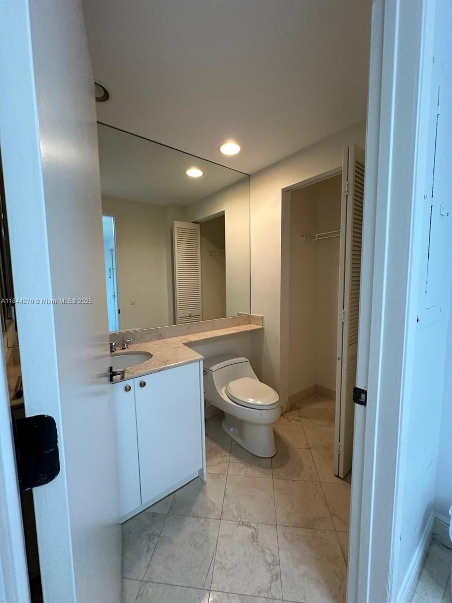 785 Crandon Boulevard, Unit 506 Key Biscayne, FL 33149 - Photo 57 of 58 a bathroom with a toilet sink and mirror