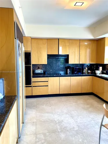a view of a kitchen with a large window