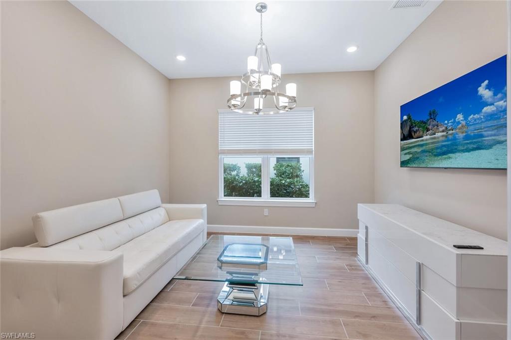 8448 Rosa Court Naples, FL 34114 - Photo 13 of 24 Bright interior space featuring wood-finish flooring and neutral wall tones