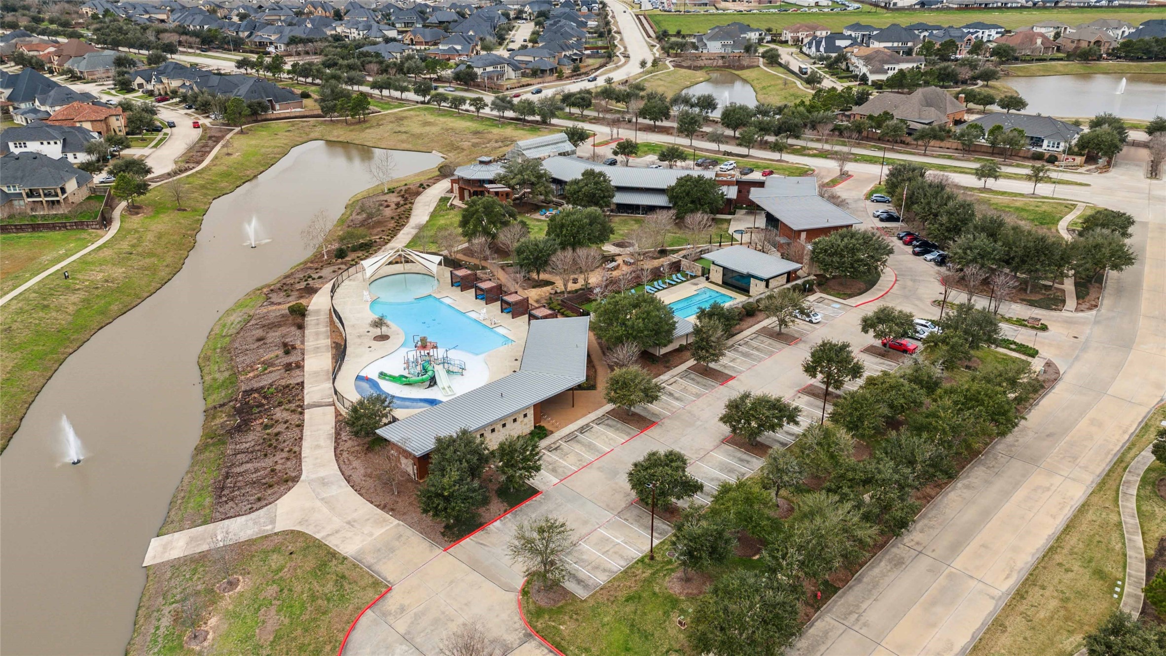 2711 Merlin Way Katy, TX 77493 - Photo 47 of 50 Amenity center with on-site restaurant, fitness center, lap pool, splash pad and resort style pool.