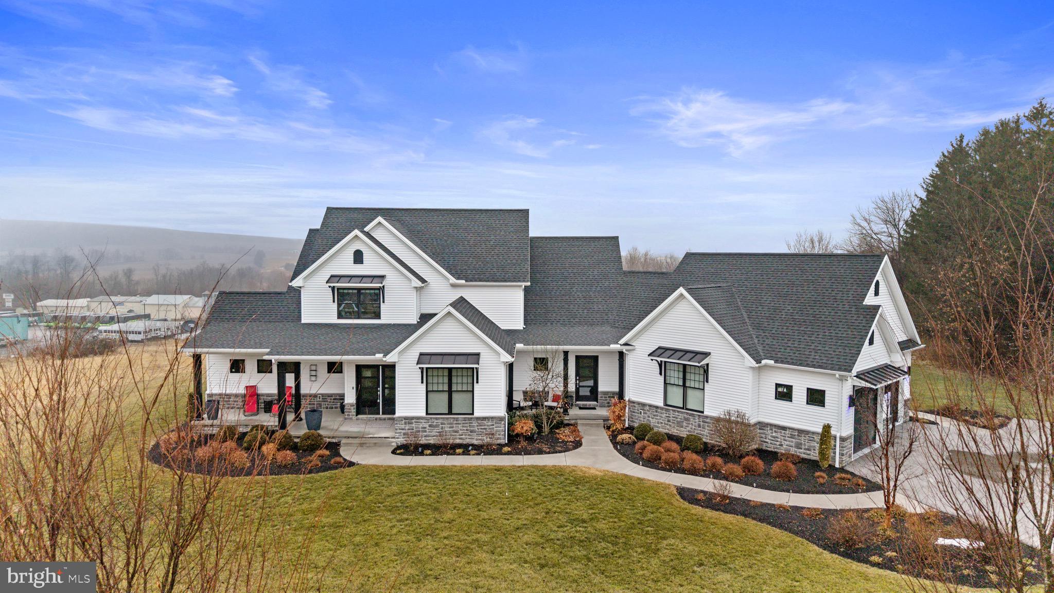 a front view of house with yard outdoor seating and barbeque oven