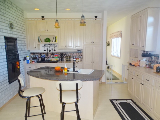 3189 West Forest Road Freeport, IL 61032 - Photo 11 of 22 a kitchen with kitchen island granite countertop a sink and a refrigerator