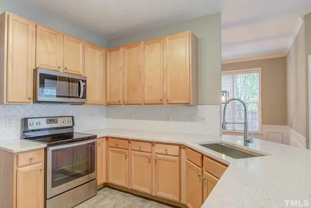a kitchen with granite countertop white cabinets and white appliances
