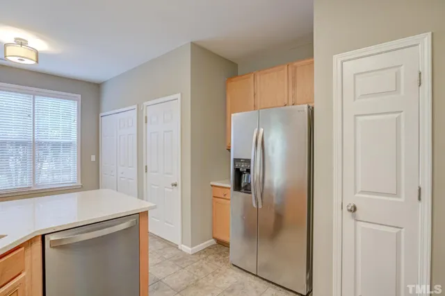 a metallic refrigerator freezer sitting in a kitchen