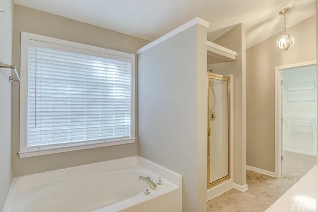 a bathroom with a bathtub and a shower