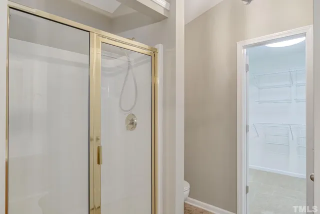 a bathroom with a glass shower door