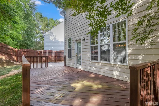 a view of a house with backyard and deck