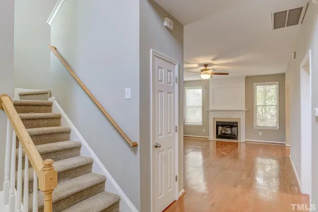a view of a livingroom with wooden floor and fireplace
