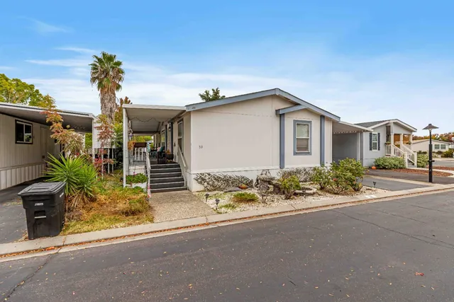 front view of house with potted plants