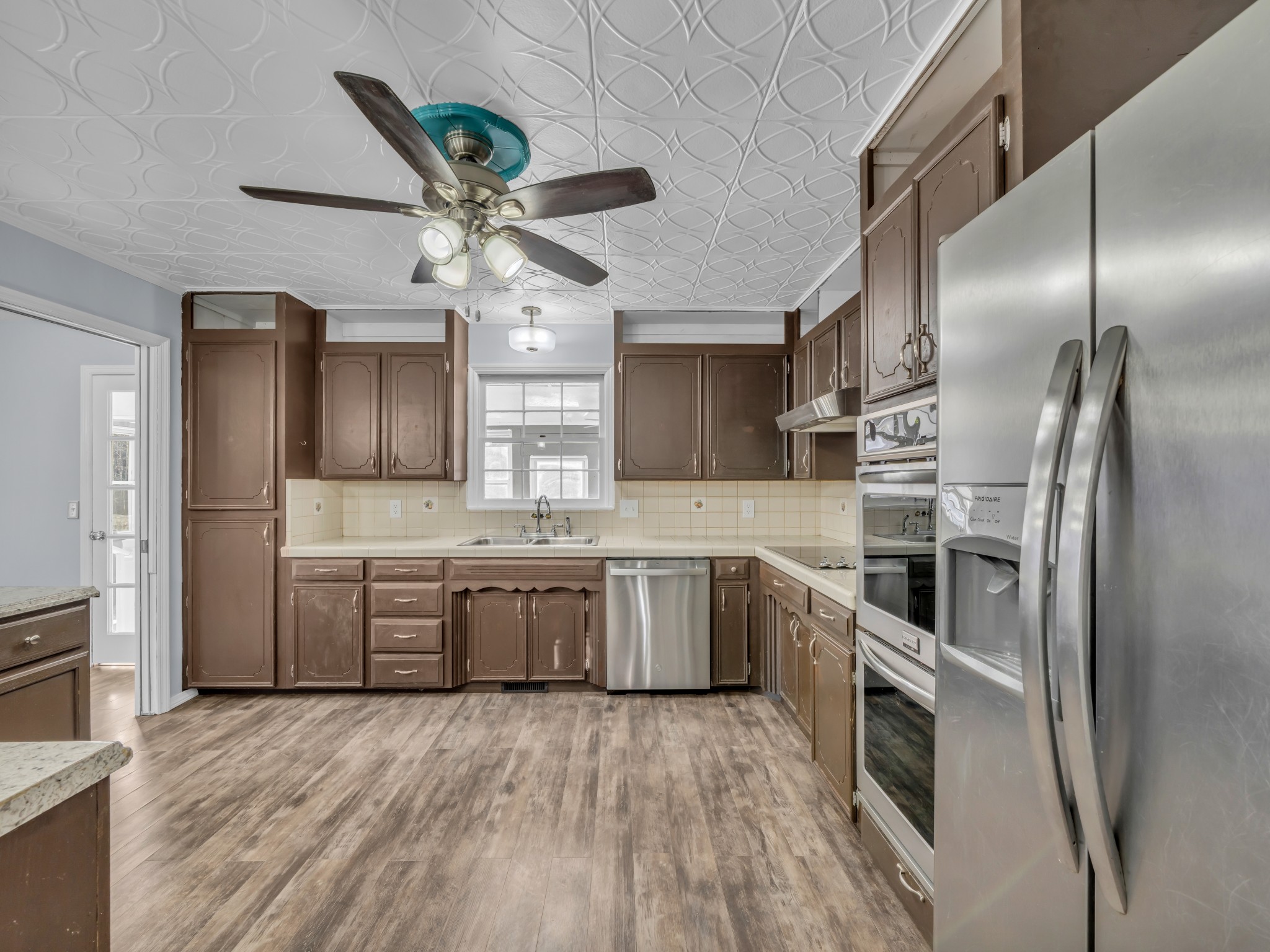 408 Rustling Oaks Drive Waverly, TN 37185 - Photo 7 of 21 a kitchen with granite countertop stainless steel appliances and wooden floor