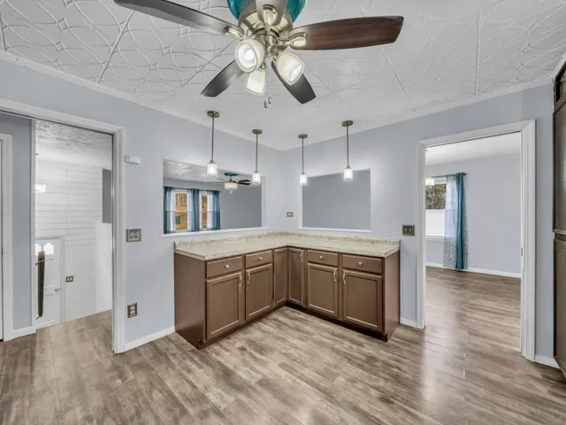 a kitchen with stainless steel appliances granite countertop a sink and a refrigerator