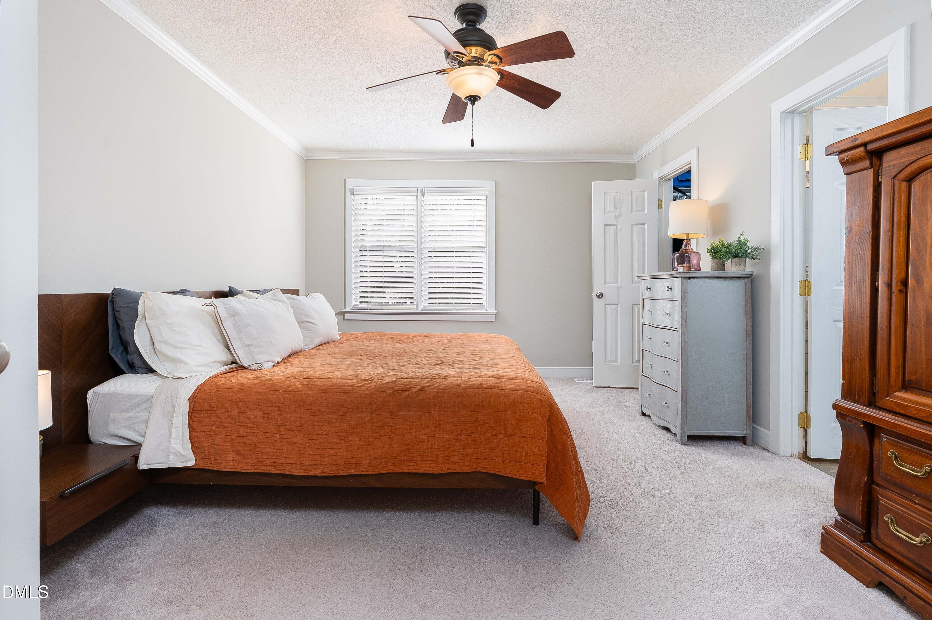 1405 Quarter Point Raleigh, NC 27615 - Photo 11 of 19 a spacious bedroom with a bed and a chandelier