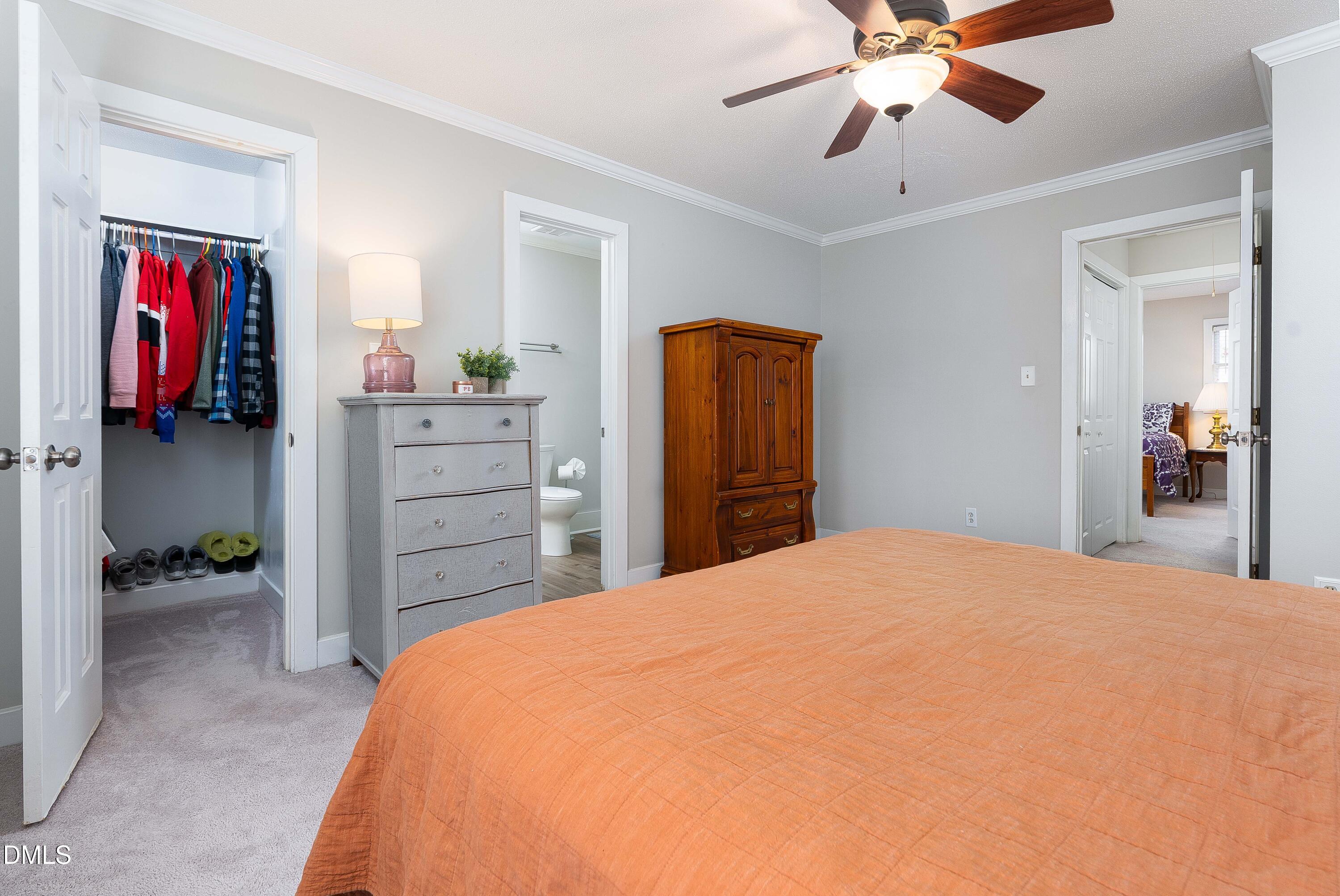 1405 Quarter Point Raleigh, NC 27615 - Photo 13 of 19 a bedroom with a bed and a chandelier