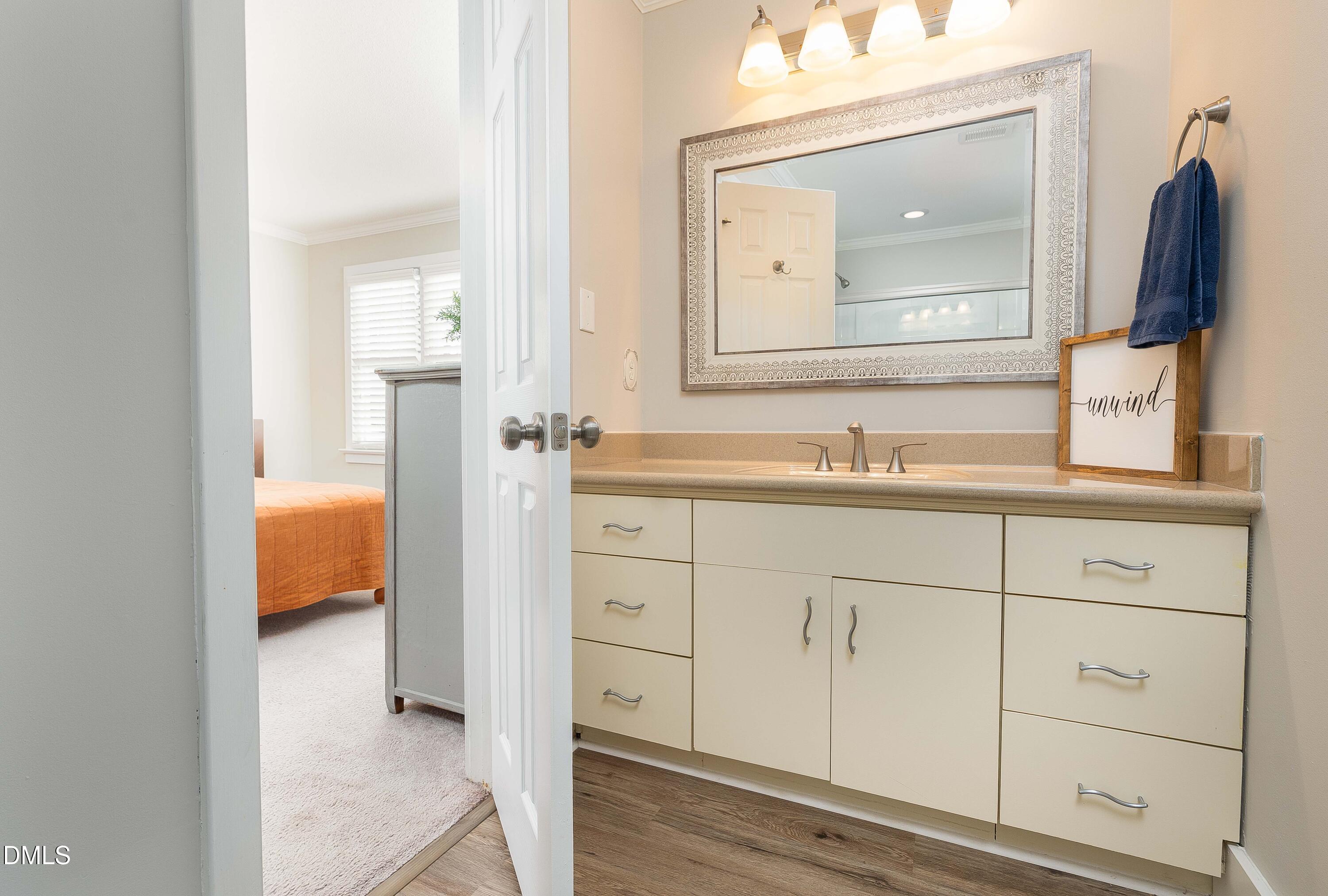 1405 Quarter Point Raleigh, NC 27615 - Photo 14 of 19 a en suite bathroom with a sink and mirror