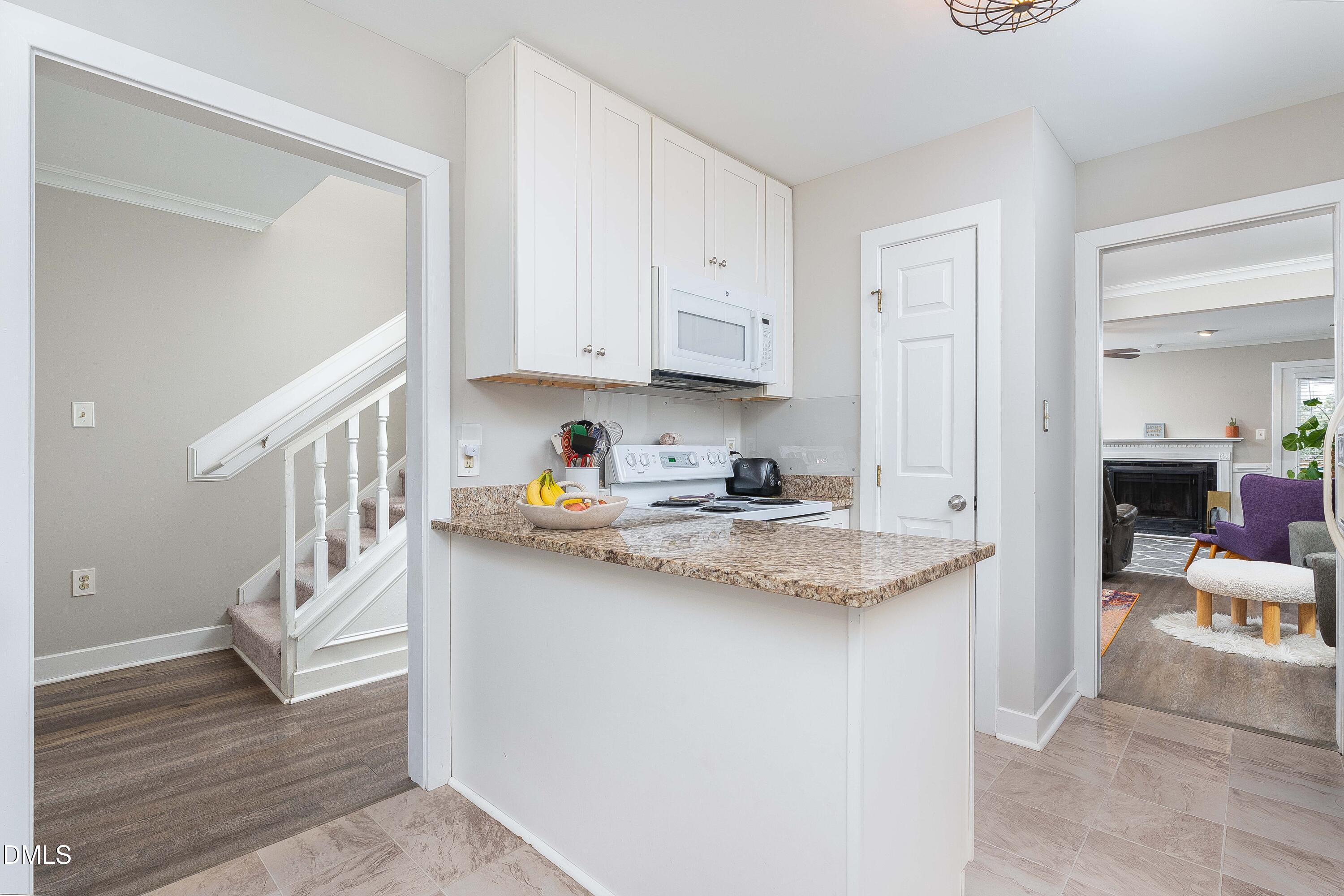 1405 Quarter Point Raleigh, NC 27615 - Photo 4 of 19 a kitchen with stainless steel appliances granite countertop a sink stove and cabinets
