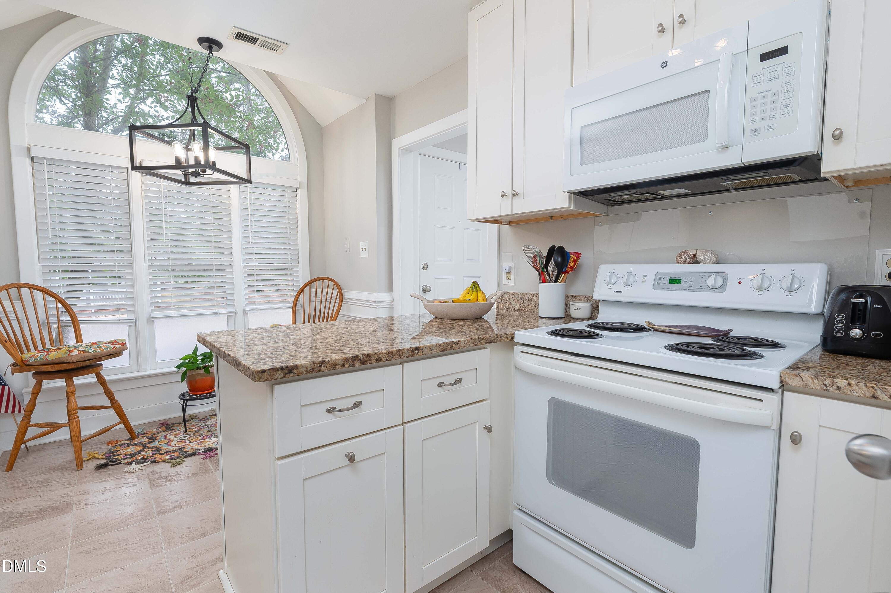 1405 Quarter Point Raleigh, NC 27615 - Photo 5 of 19 a kitchen with white cabinets and appliances