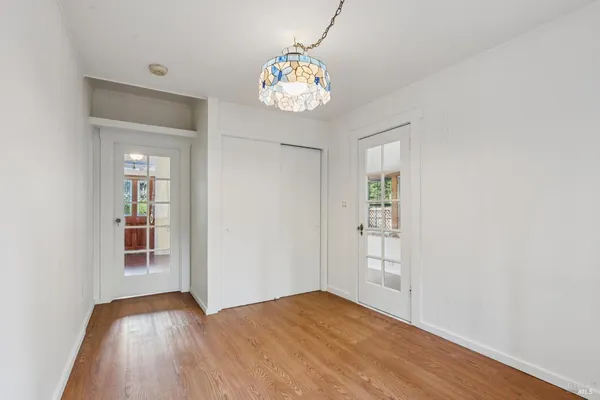 a view of an empty room with a fireplace and a window