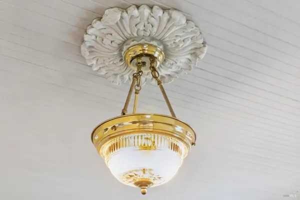 a front view of a house with a garden and plants