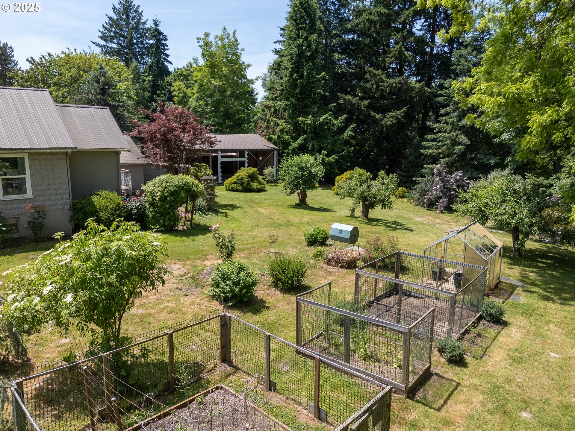 16163 French Prairie Road Northeast Woodburn, OR 97071 - Photo 22 of 47 a view of a patio with table and chairs under an umbrella