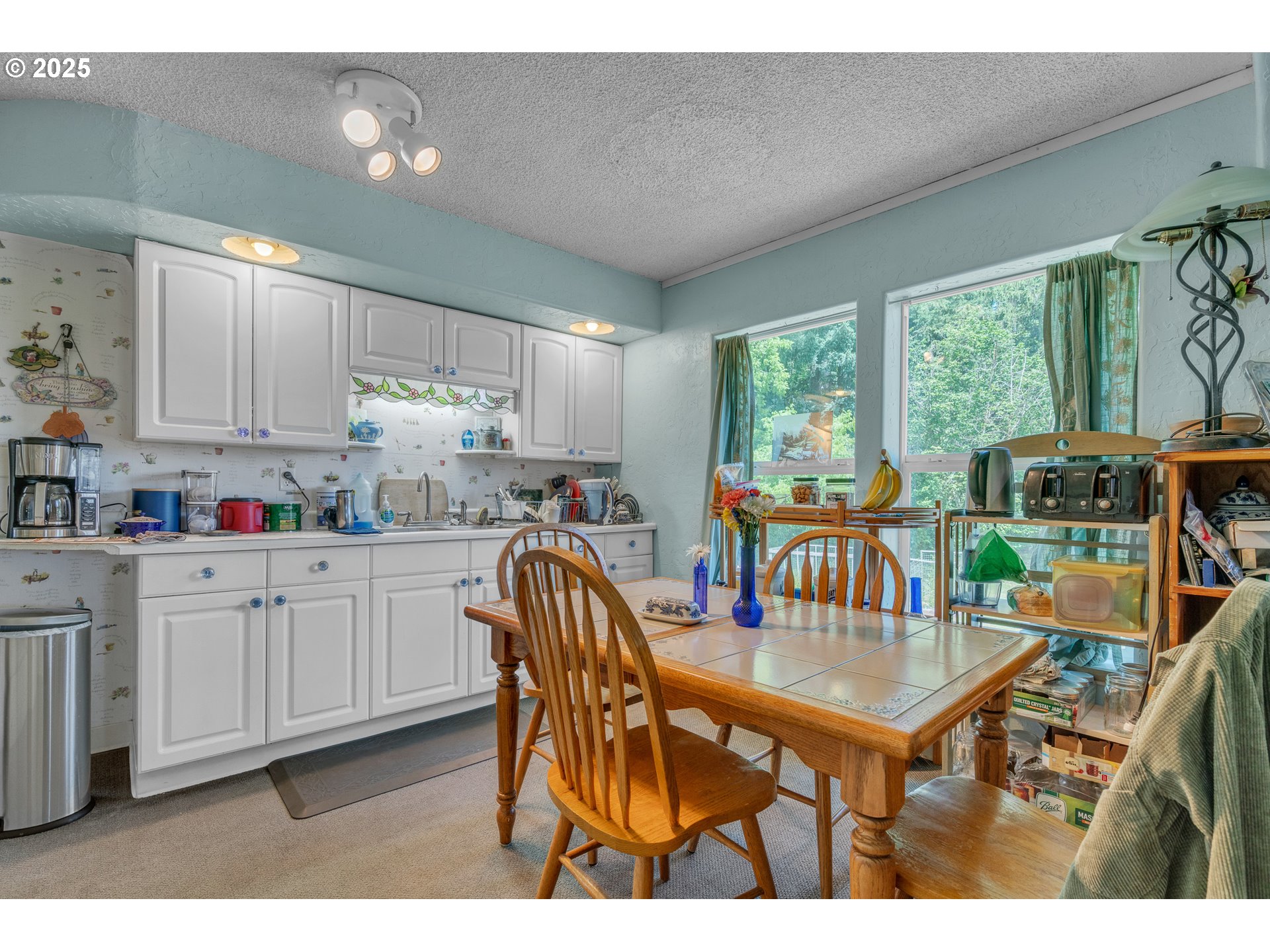 16163 French Prairie Road Northeast Woodburn, OR 97071 - Photo 9 of 47 a dinning table and chairs in a kitchen