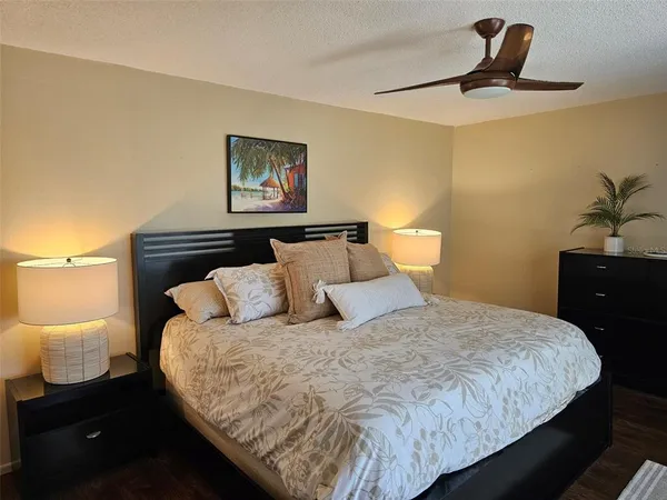 a bedroom with a large bed and a large window