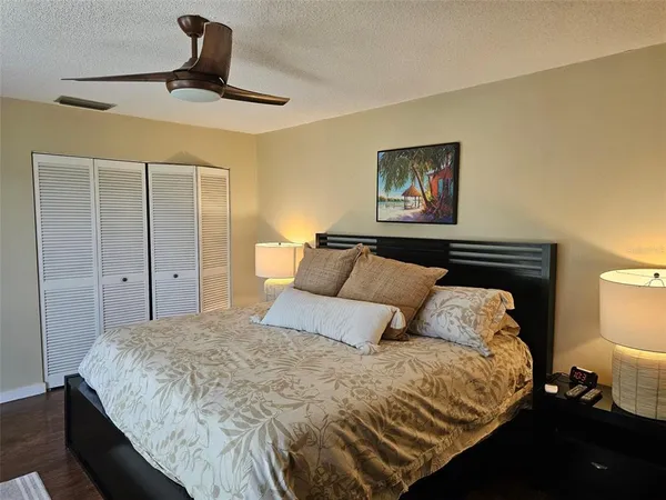 a bedroom with a large bed and a large window