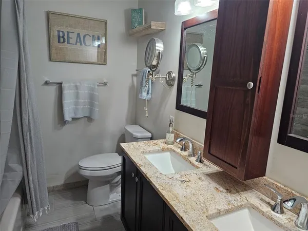 a bedroom with bed and a chandelier