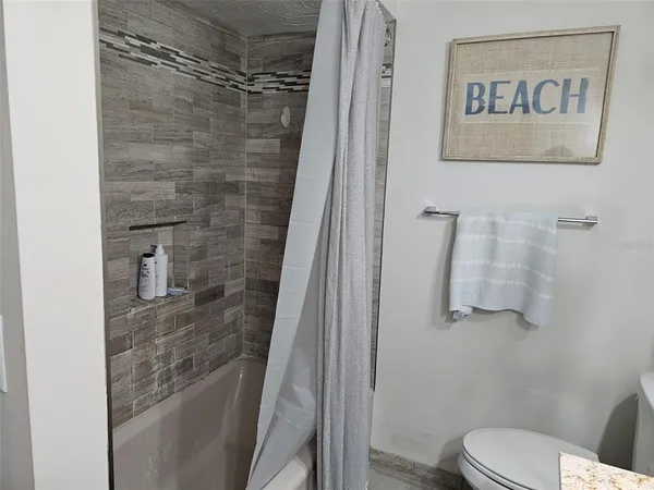 a bedroom with a bed mirror and a window