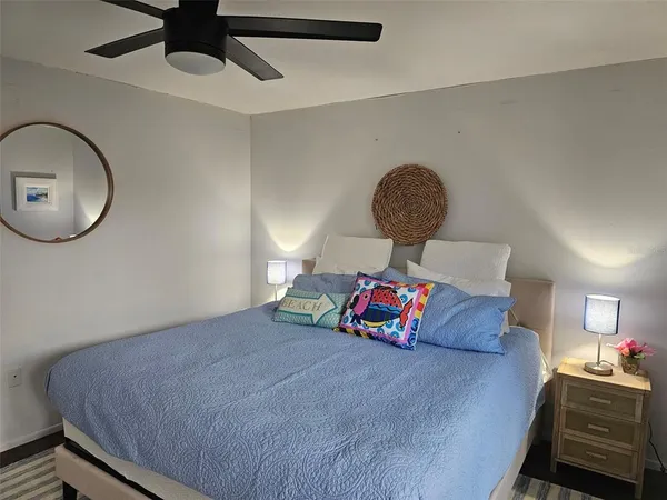 a bedroom with a large bed and a large window