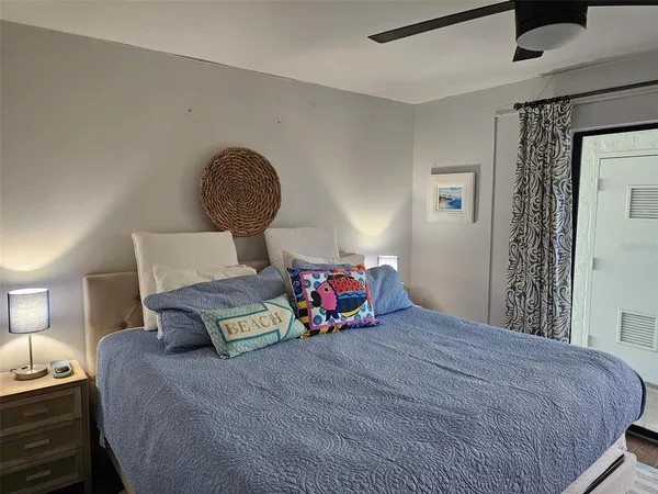 a bedroom with a bed and a mirror