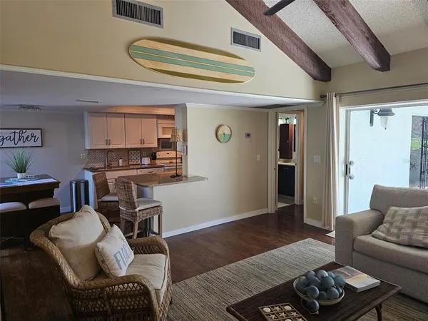 a living room with furniture a flat screen tv and a floor to ceiling window